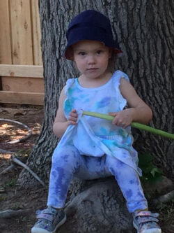 Granddaughter Abby sitting under a tree